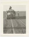 "1950's 400 series": Expedition members standing on and next to truck, and chains laid out ahead of wheels (print is a cropped image)