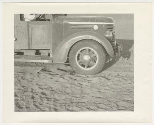 "1950's 400 series": Front of expedition truck, with sand and chains (print is a cropped image)