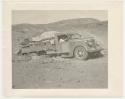 "1950's 400 series": Expedition members pushing and driving a truck out of the sand (print is a cropped image)