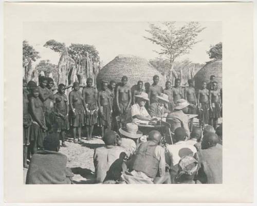 "Glossy duplicates of / 1950 Merl La Voy prints / 400 series": Government officials collecting grain tax from Ovambo people (print is a cropped image)