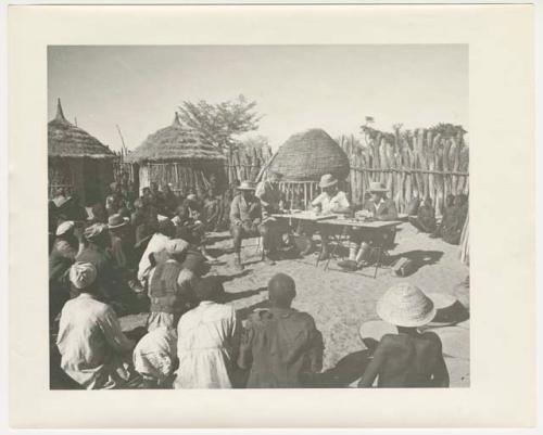 "Glossy duplicates of / 1950 Merl La Voy prints / 400 series": Government officials collect grain tax from Ovambo people (print is a cropped image)