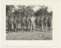 "Glossy duplicates of / 1950 Merl La Voy prints / 400 series": Group of men standing in a line (print is a cropped image)