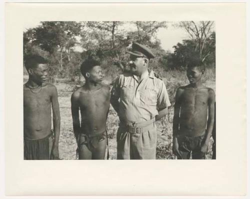 "Glossy duplicates of / 1950 Merl La Voy prints / 400 series": Group of men standing in a line (print is a cropped image)