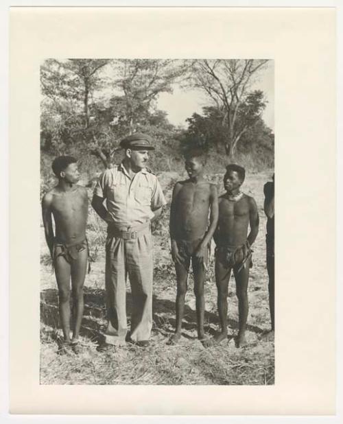 "Glossy duplicates of / 1950 Merl La Voy prints / 400 series": Group of men standing in a line (print is a cropped image)