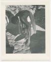 "Glossy duplicates of / 1950 Merl La Voy prints / 400 series": Woman leaning over and holding a basket (print is a cropped image)