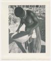 "Glossy duplicates of / 1950 Merl La Voy prints / 400 series": Woman standing and holding a basket (print is a cropped image)