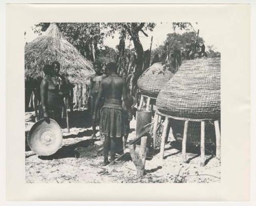 "1950 '400 Series' / 87 B/W prints (some duplicates) / Ovamboland": Women standing next to storage baskets (print is a cropped image)