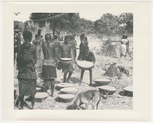 "1950 '400 Series' / 87 B/W prints (some duplicates) / Ovamboland": Women putting baskets of grain down (print is a cropped image)