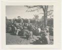 "1950 '400 Series' / 87 B/W prints (some duplicates) / Ovamboland": Group of people sitting, with storage baskets in background (print is a cropped image)