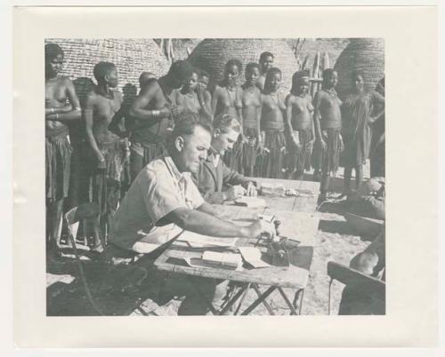 "1950 '400 Series' / 87 B/W prints (some duplicates) / Ovamboland": Government officials collecting grain tax from Ovambo people (print is a cropped image)