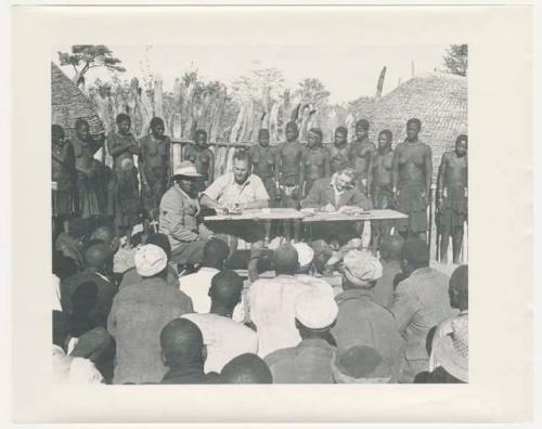 "1950 '400 Series' / 87 B/W prints (some duplicates) / Ovamboland": Government officials collecting grain tax from Ovambo people (print is a cropped image)