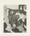 "1950 '400 Series' / 87 B/W prints (some duplicates) / Ovamboland": Person sitting and holding a baby (print is a cropped image)