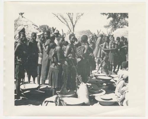 "1950 '400 Series' / 87 B/W prints (some duplicates) / Ovamboland": Women standing near sacks and baskets of grain (print is a cropped image)