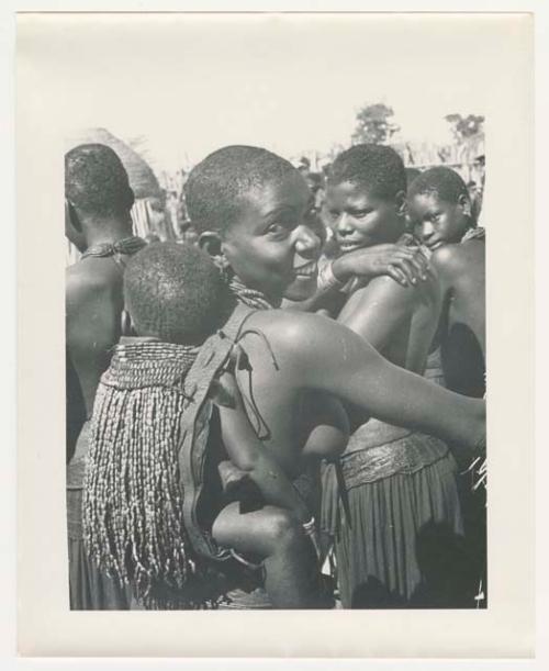 "1950 '400 Series' / 87 B/W prints (some duplicates) / Ovamboland": Woman carrying a child on her back in a beaded carrying bag (print is a cropped image)