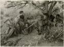 [No folder title]: Women and children of Oukwane's group and “visiting group" sitting under a tree







