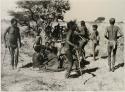 [No folder title]: Men dancing around a group of women seated







