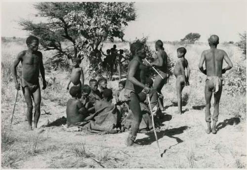 [No folder title]: Men dancing around a group of women seated







