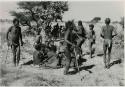 [No folder title]: Men dancing around a group of women seated







