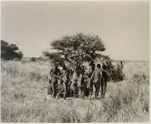 [No folder title]: Men dancing around a group of women seated







