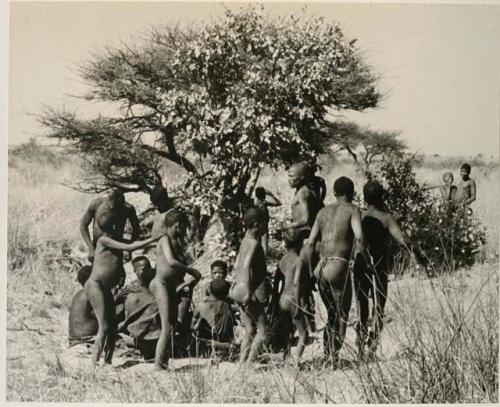 [No folder title]: Men dancing around a group of women seated







