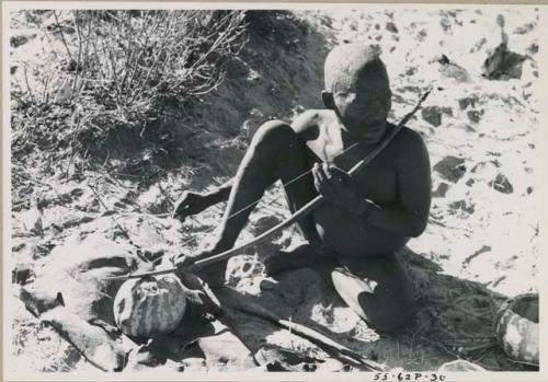 [No folder title]: Oukwane playing a musical bow, seated








