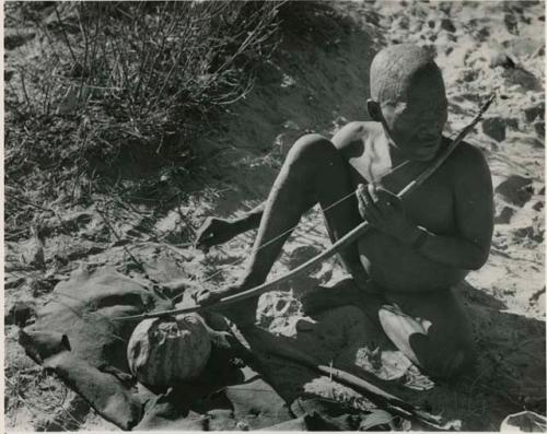 [No folder title]: Oukwane playing a musical bow, seated








