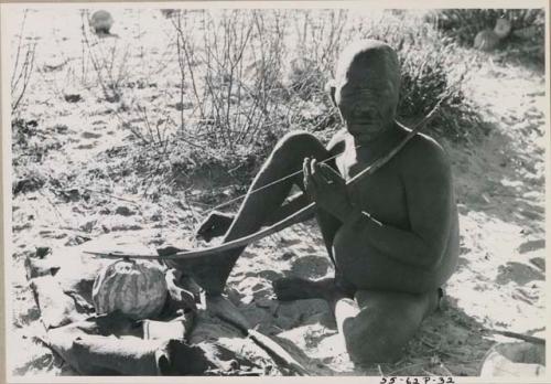 [No folder title]: Oukwane playing a musical bow, seated








