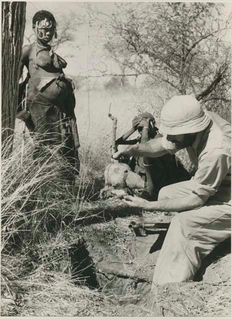 [No folder title]:  Robert Story holding a root, close-up






