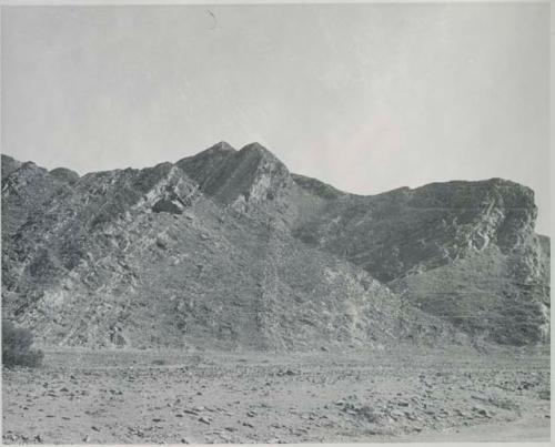 "1950 400 series  43 prints / Kunene River, Kaokoveld, Ovamboland / Merle LaVoy & L.K.M": View of hill, showing tipped strata (print is a cropped image)