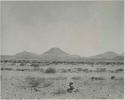 "1950 400 series  43 prints / Kunene River, Kaokoveld, Ovamboland / Merle LaVoy & L.K.M": Small pile of rocks, with hills in the distance (print is a cropped image)