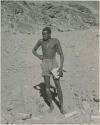 "1950 400 series  43 prints / Kunene River, Kaokoveld, Ovamboland / Merle LaVoy & L.K.M": Man standing (print is a cropped image)