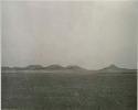"1950 400 series  40 prints / Kaokoveld": Landscape, with buttes in distance (print is a cropped image)