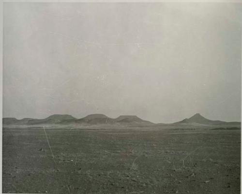 "1950 400 series  40 prints / Kaokoveld": Landscape, with buttes in distance (print is a cropped image)