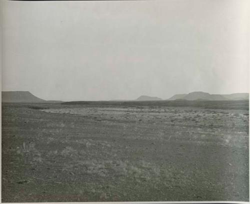 "1950 400 series  40 prints / Kaokoveld": Landscape, with buttes in distance (print is a cropped image)