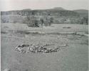 "1950 400 series  40 prints / Kaokoveld": Pile of stones in circle with space for entrance (print is a cropped image)