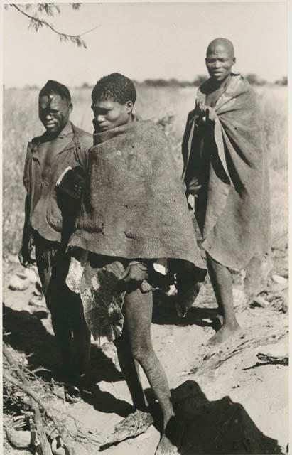 [No folder title]: Three men, members of a visiting band from Okwa, standing






