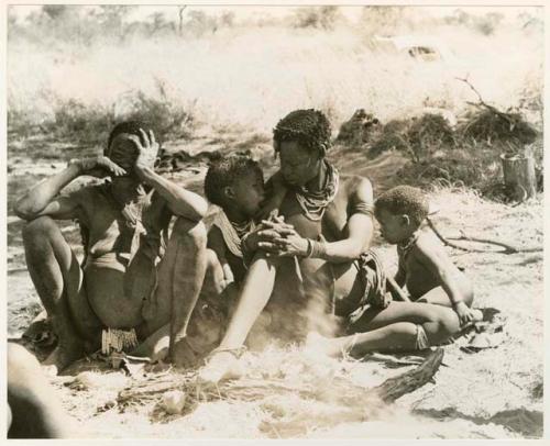 [No folder title]: /Naoka, Di!ai's mother, and Di!ai with her two sons, Debe and /Gaishay, seated close together (print is a cropped image)