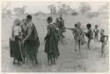 [No folder title]: Women and children playing a game (print is a cropped image)