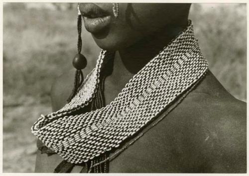 [No folder title]: Close-up of ostrich eggshell bead headband worn by women (print is a cropped image)