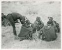 [No folder title]: Medicine man curing another person from a group of seated people (print is a cropped image)