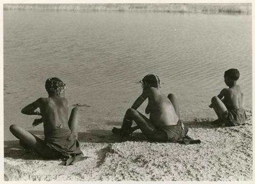 [No folder title]: Three women bathing, seen from behind (print is a cropped image)