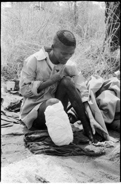 "/Qui Hunter" seated with his foot bandaged