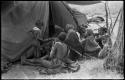 Women waiting outside a tent in which expedition members are dressing /Naoka (/Qui's second wife) and her daughter, /Khoa