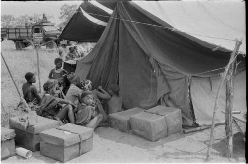 Women waiting outside a tent in which expedition members are dressing /Naoka (/Qui's second wife) and her daughter, /Khoa