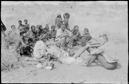 Group of people gathering around "/Qui Hunter" with Kernel Ledimo, John Marshall, and ≠Toma present