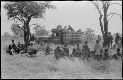 The expedition and a group of Ju/'hoansi gathered around the truck