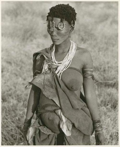 [No folder title]: Portrait of ≠Gisa (daughter of /Gasa and wife of Dam) showing her ornaments and strings of ostrich eggshell beads (print is a cropped image)