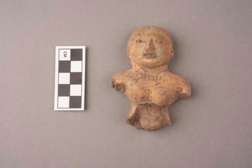 Seated clay figurine