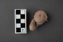 Archaic pottery figurine- head with arm bent to head