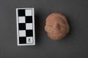 Archaic pottery figurine- head with hair parted on side